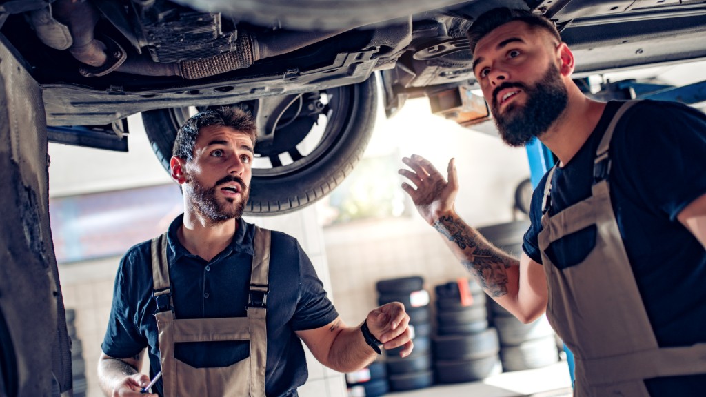 Mechanics inspecting a vehicle on a lift