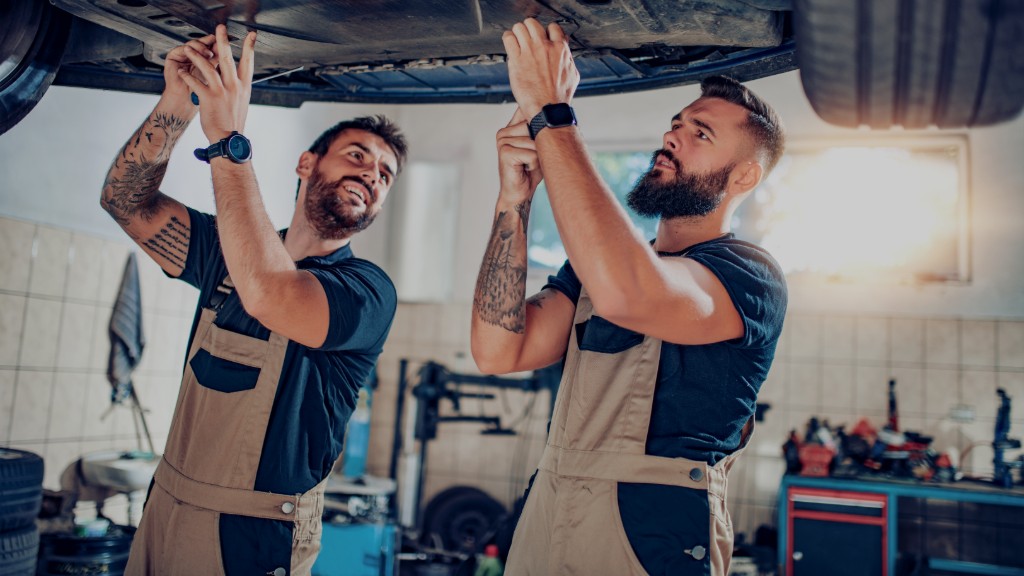 Technicians working underneath a raised vehicle